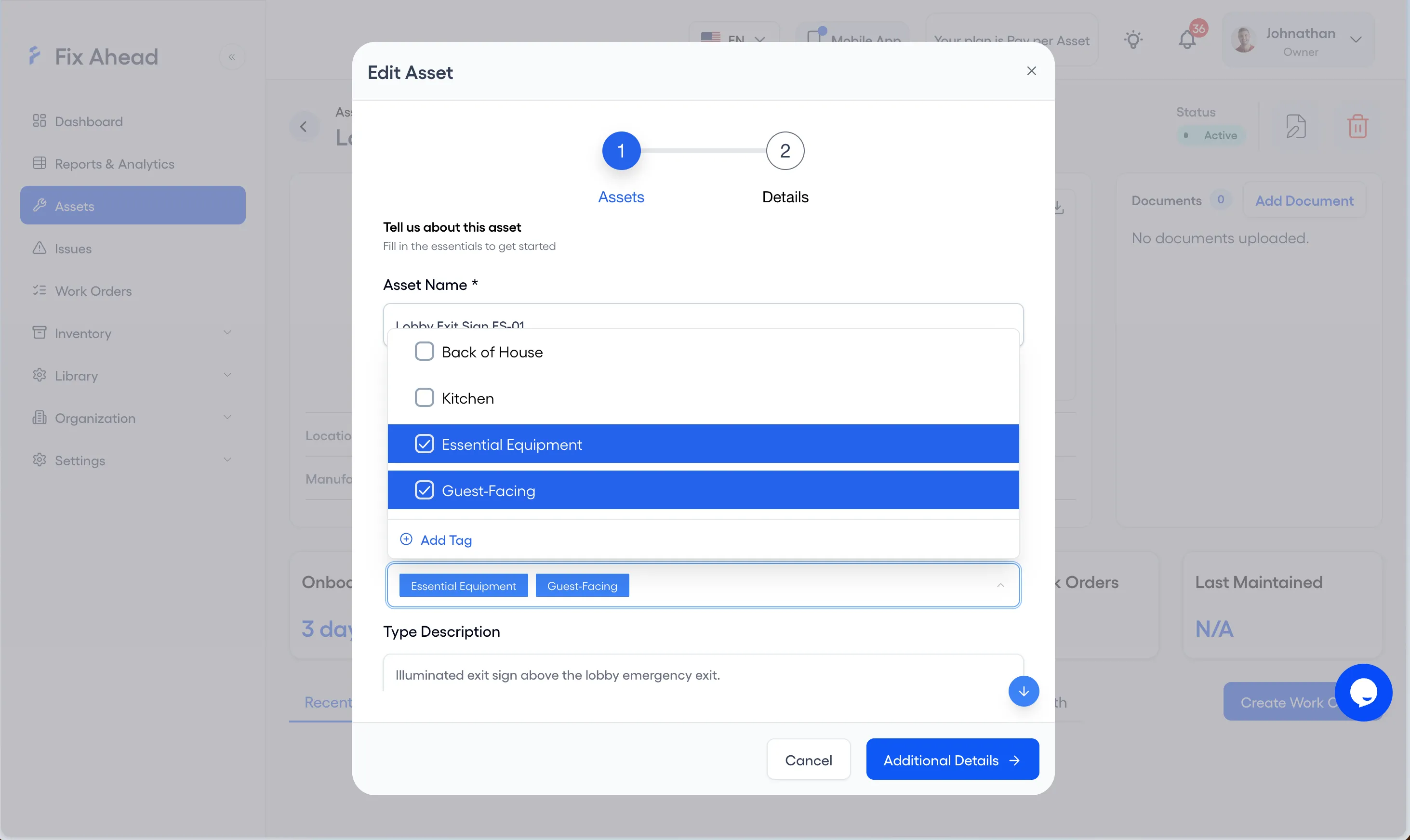 The Edit Asset modal for Lobby Exit Sign ES-01 with the tags list open: Back of House and Kitchen are unchecked, Essential Equipment and Guest-Facing are checked, and Add Tag sits beneath them. The two chosen tags show in the tags field below.